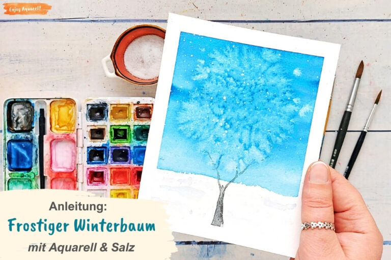 Hand hält Bild mit winterlichem Baum gemalt mit Aquarellfarben und Salz
