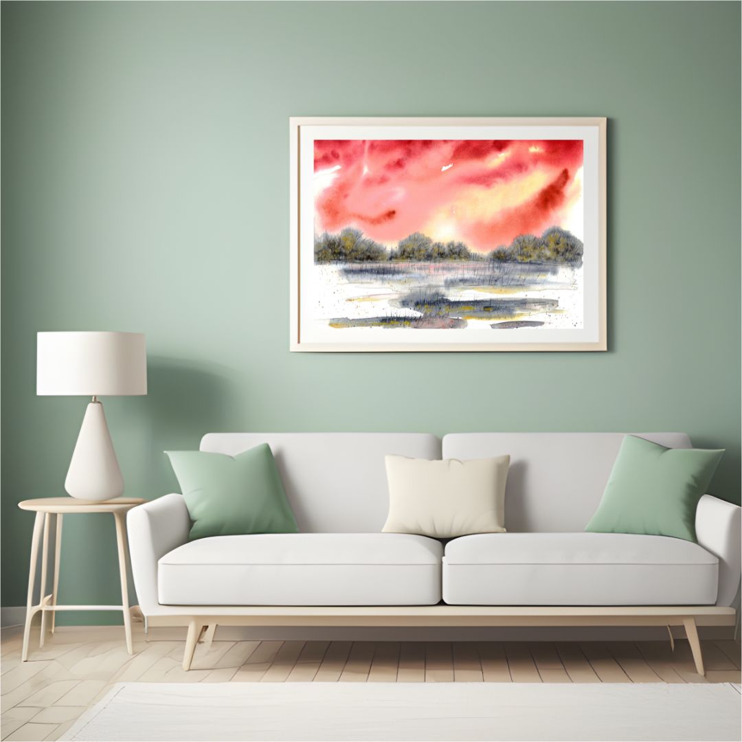 Aquarell halb abstrakt mit rotem Himmel und grau-goldener Landschaft an grüner Wand über hellem Sofa
